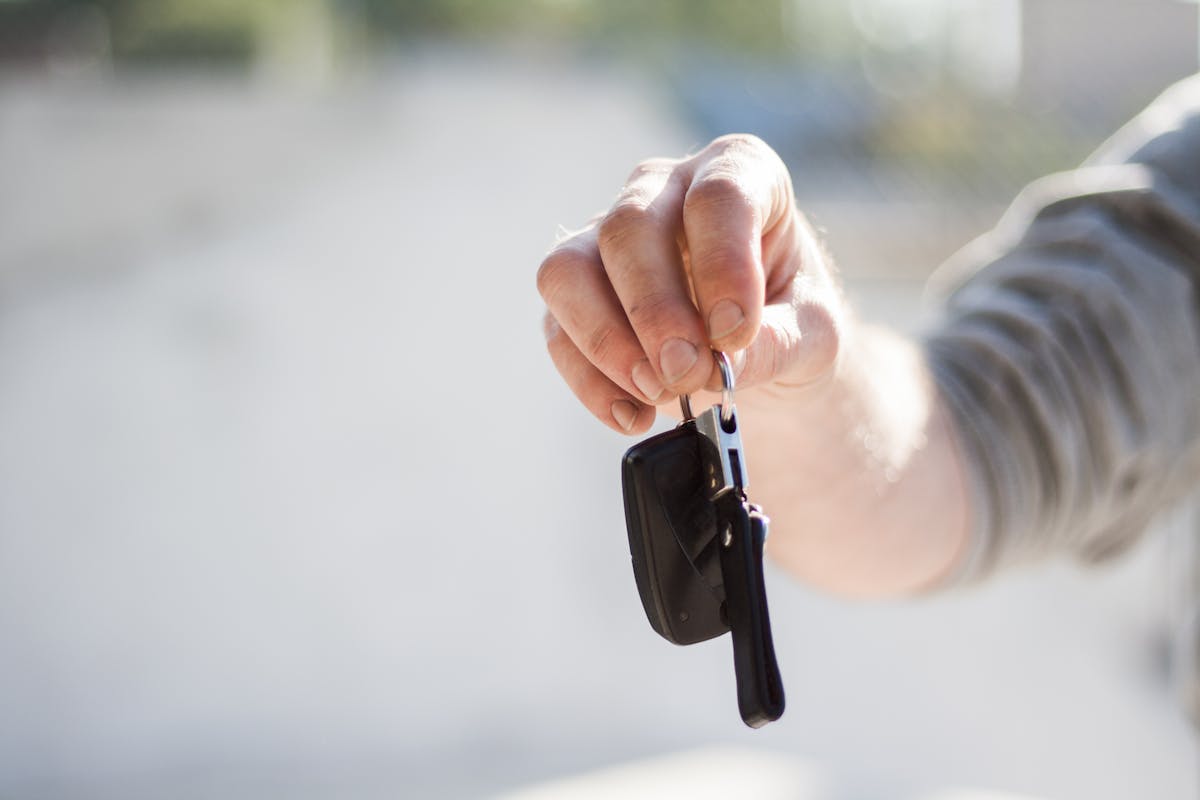 A driver holding car keys while shopping for auto insurance